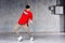 Young freestyle dancer on grey background.