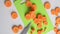 Young fresh carrots cut into circles on cutting board on kitchen table with knife top view. Cutting vegetables close-up