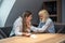 Young friend woman comforting her sad depressed colleague in office who crying after mistake at work on new company project and is