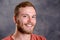 Young friendly, bearded man in red shirt