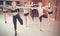 Young friendly girls performing modern dance in fitness studio