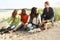 Young Friends Enjoying Picnic On Beach