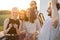 Young friends hang out at rooftop terrace on sunset