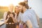 Young friends hang out at rooftop terrace on sunset