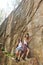 Young friends near steep cliff on summer day