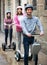 Young friends posing on segways on city street