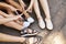 Young friends sitting on the ground in summer. Legs of girls.