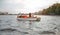 Young friends sitting in pedal boat enjoying summertime