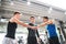 Young friends standing and talking in modern crossfit gym, making fist bump.