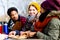 Young friends talking at picnic outdoors in the park