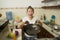 Young frustrated Asian woman in domestic chores stress - lifestyle home portrait of beautiful overwhelmed and stressed Chinese