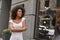 Young and full of energy. Portrait of gorgeous Afro American woman standing outdoors with crossed arms and smiling