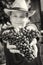 Young funny boy with bunch of grapes in hands, black and white