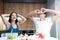 Young funny couple cooking breakfast in the kitchen man closes his eyes with mushrooms while his beloved wife holds