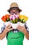 Young funny gardener with tulips isolated oin