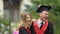 Young funny male and female graduates laughing, celebrating graduation, success