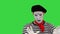 Young funny mime behind an invisible wall on a Green Screen, Chroma Key.