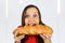 Young funny pretty woman eats long loaf