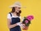 Young gardener holding flower pot with beautiful pelargonium