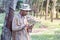 Young gardener man holding digital tablet in garden