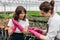 Young gardeners working in the greenhouse. Florist concept