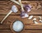 Young garlic heads and peeled cloves on a wooden table. Coarse salt in a clay salt shaker. Rustic table made of brown boards,