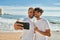 Young gay couple smiling happy making selfie by the smartphone at the beach