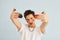 Young gay man is standing in the studio and posing for a camera. Shows gestures