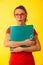 Young geek woman in red t shirt over vibrant yellow background