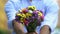 Young gentleman presenting beautiful bouquet of flowers to camera, pleasant gift