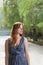 Young ginger haired women posing outside in city park