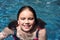 Young girl (12) smiling in pool