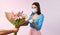 Young girl accepting apology. Giving girl a bouquet of colorful wilted tulips, pandemic. Neon pink background