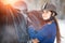 Young girl adjusting stirrups before riding horse