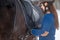 Young girl adjusting stirrups before riding horse