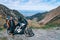 Young girl with adventure motorcycle. woman rider. Top of the mountain road. Motorbike vacation. Travel and active lifestyle