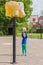 Young girl aiming ball at basket like elephant
