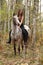 Young girl with appaloosa horse in autumn