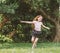 Young girl with arms open enjoying her freedom at the park so happy relax dance