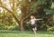 Young girl with arms open enjoying her freedom at the park so happy relax dance.