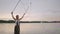 A young girl artist shows magic tricks using huge soap bubbles. Create soap bubbles using sticks and rope at sunset to