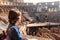 Young girl with backpack exploring inside the Colosseum