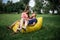 Young girl and balding man relaxing on air hammock in the garden. Spring or summer love story