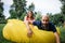 Young girl and balding man relaxing on air hammock in the garden. Spring or summer love story