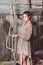 Young girl in the barn with her hand of rope