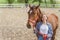 Young Girl With A Bay Horse Standing In The Stable Girl Holding Horse Lead Rope