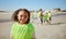 Young girl, beach cleaning and environment portrait with climate change and recycling, volunteer vest and kid clean