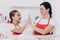 Young Girl and beautiful Mother in the Kitchen.