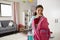 Young Girl In Bedroom Zipping Up Bag Ready For School