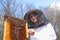 A young girl beekeeper in apiary